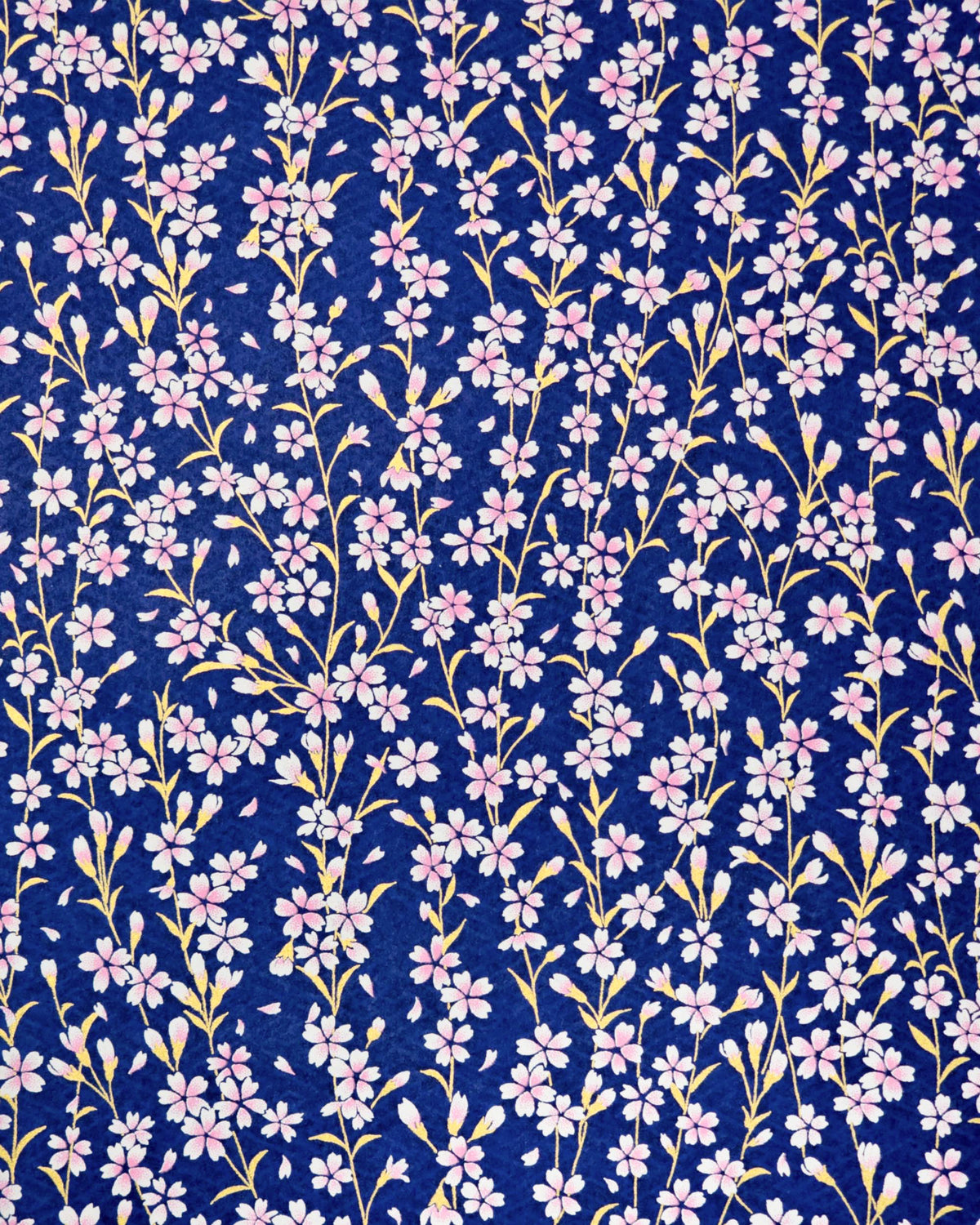 Japanese chiyogami paper featuring pink and white cherry blossoms with metallic gold stems and leaves on a dark blue background. 