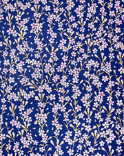 Japanese chiyogami paper featuring pink and white cherry blossoms with metallic gold stems and leaves on a dark blue background. 