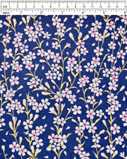 Japanese chiyogami paper featuring pink and white cherry blossoms with metallic gold stems and leaves on a dark blue background, shown next to a ruler for size reference.