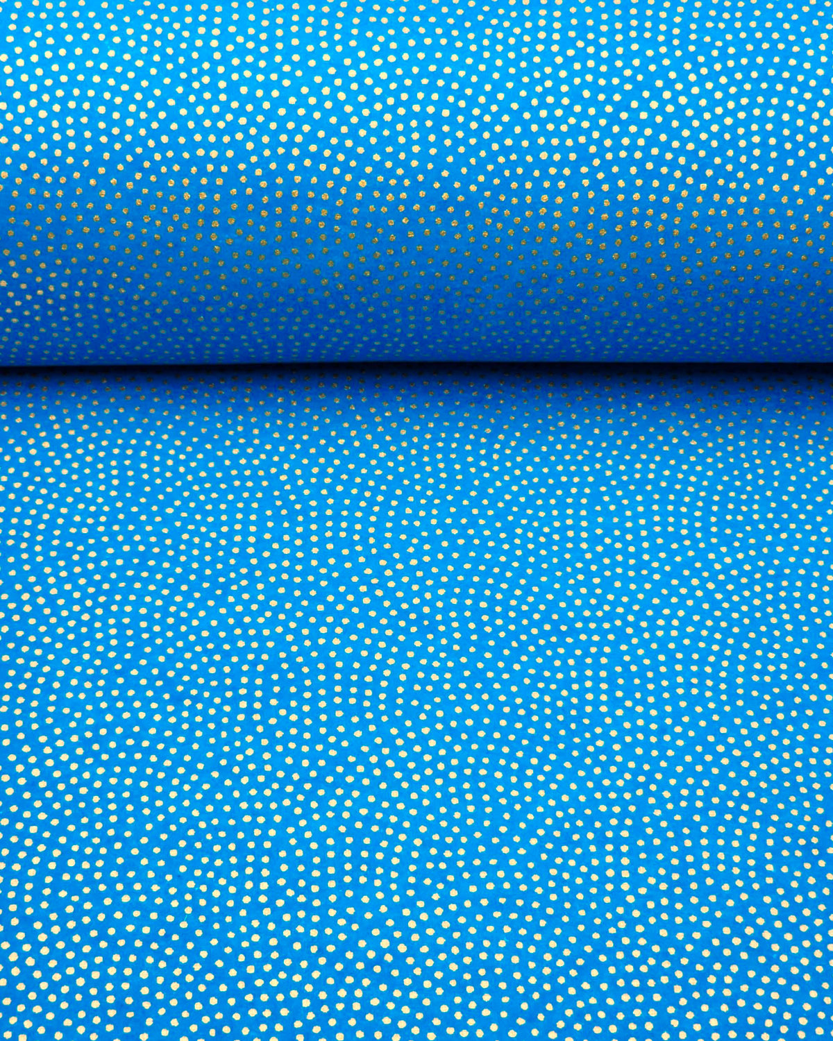 Japanese chiyogami paper featuring a metallic gold "same komon" (sharkskin) design on a blue background, shown rolled to highlight the design.
