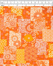 Japanese chiyogami paper featuring a patchwork-style arrangement of assorted floral and traditional Japanese patterns in various shades of orange and white, shown next to a ruler for size reference.
