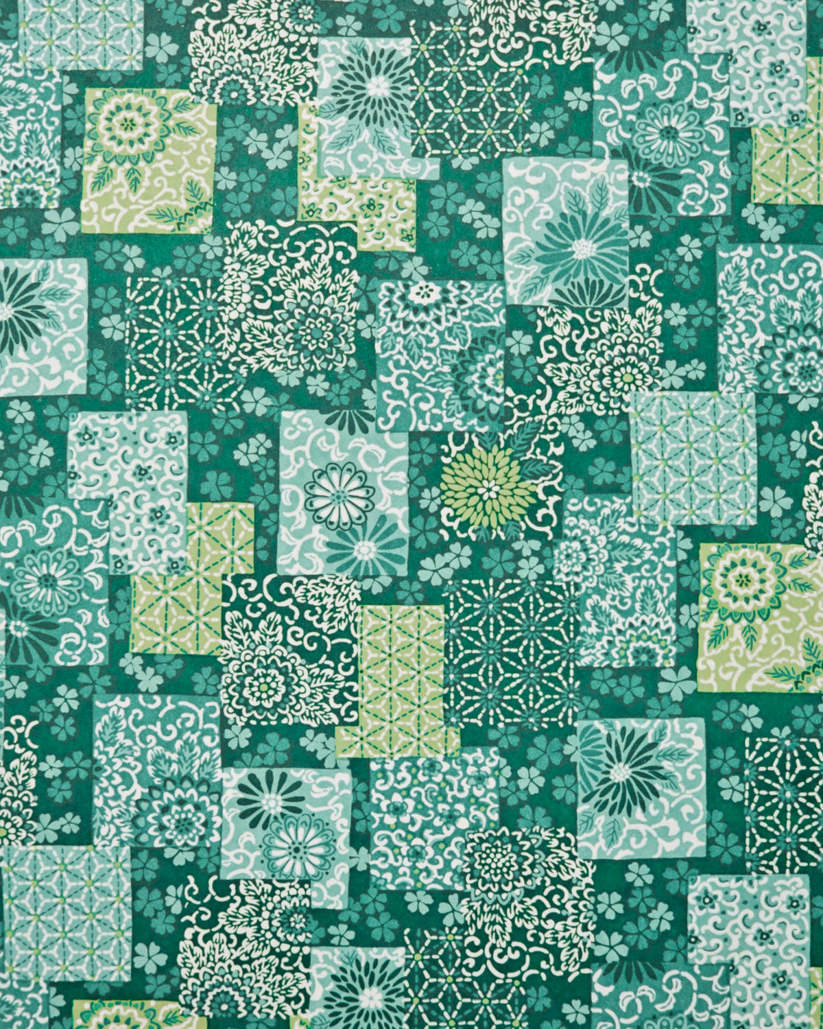 Japanese chiyogami paper featuring a patchwork-style arrangement of assorted floral and traditional Japanese patterns in various shades of green and white. 