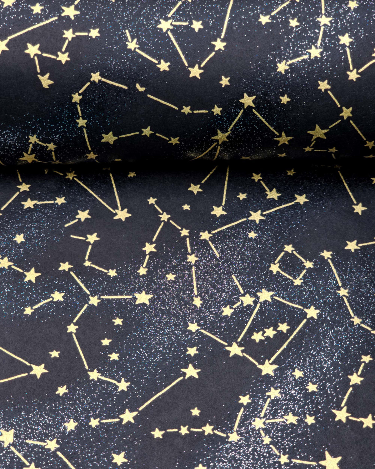 Japanese chiyogami paper featuring metallic gold stars and constellations scattered across a black background with shimmering metallic silver stardust, shown next to a ruler for size reference.
