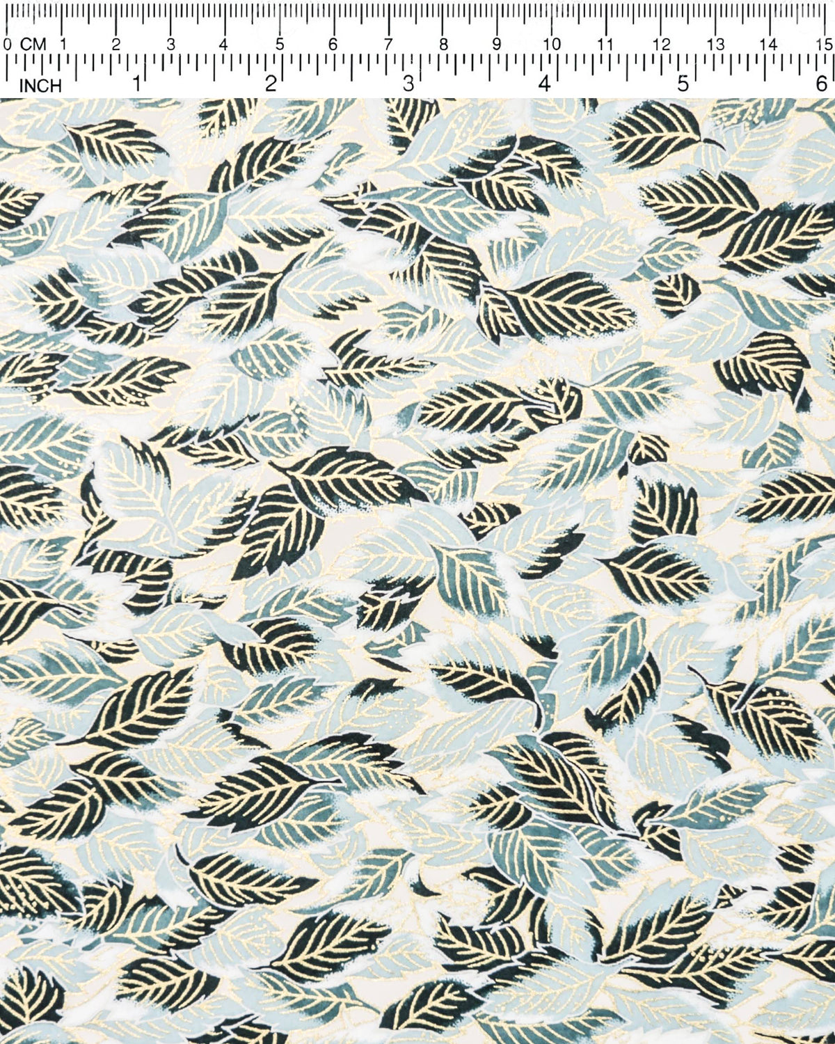 Japanese chiyogami paper featuring dark green, light blue-green, and white leaves on a white background with metallic gold details, shown next to a ruler for size reference.