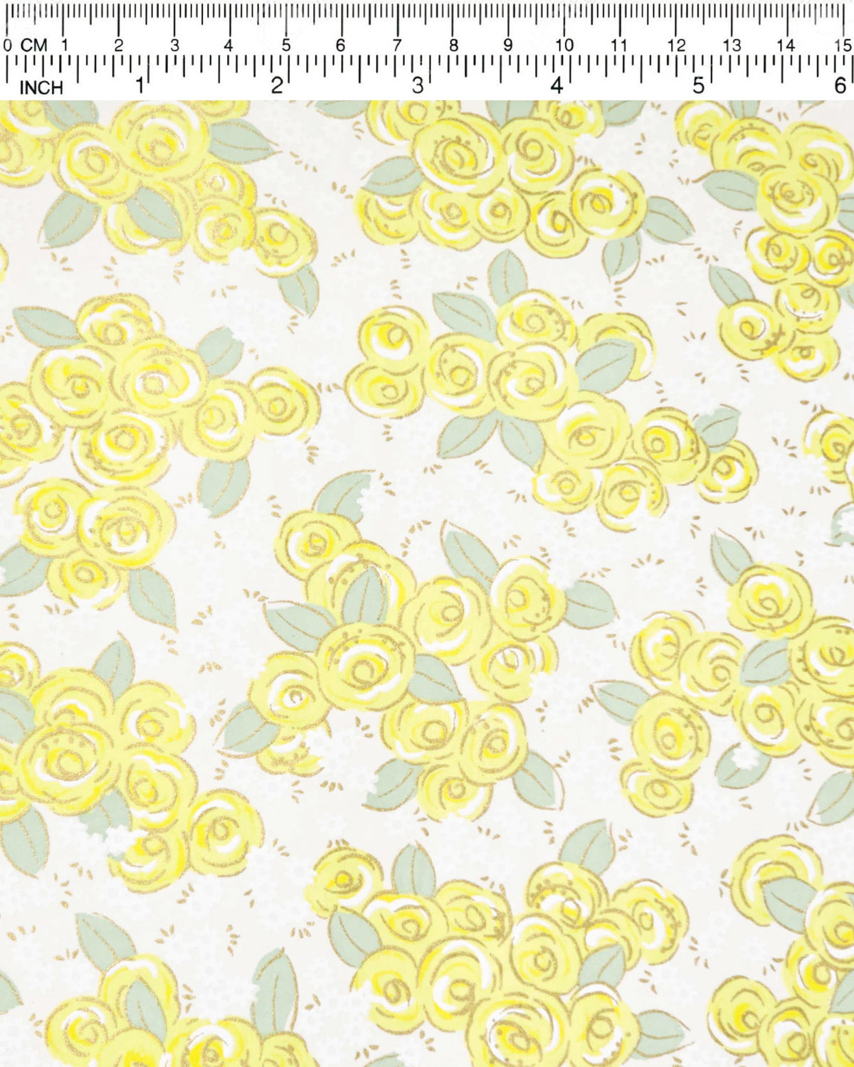 Japanese chiyogami paper featuring yellow and white roses with light green leaves and smaller white flowers on a white background with metallic gold details, shown next to a ruler for size reference.