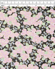 Japanese chiyogami paper featuring purple and white roses with light green leaves and smaller white flowers on a black background with metallic gold details, shown next to a ruler for size reference.