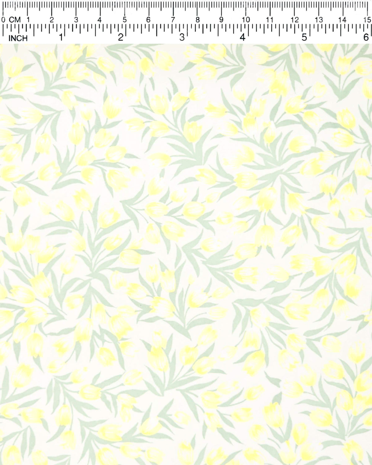 Japanese chiyogami paper featuring pale yellow and white tulips with light green leaves on a white background, shown next to a ruler for size reference.