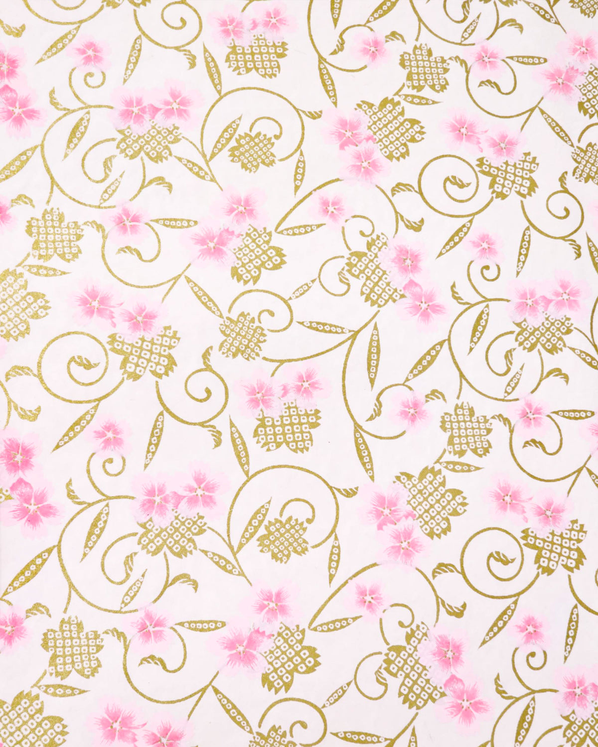 Japanese chiyogami paper featuring pink cherry blossoms alongside gold cherry blossoms and leaves decorated with a traditional kanoko (fawn) pattern on a light pink background. 