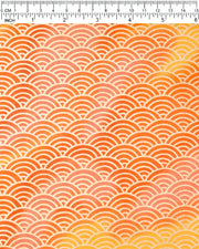 Japanese chiyogami paper featuring a large metallic gold traditional seigaiha (wave crest) pattern on a flowing background in various shades of orange, shown rolled to highlight the design.
