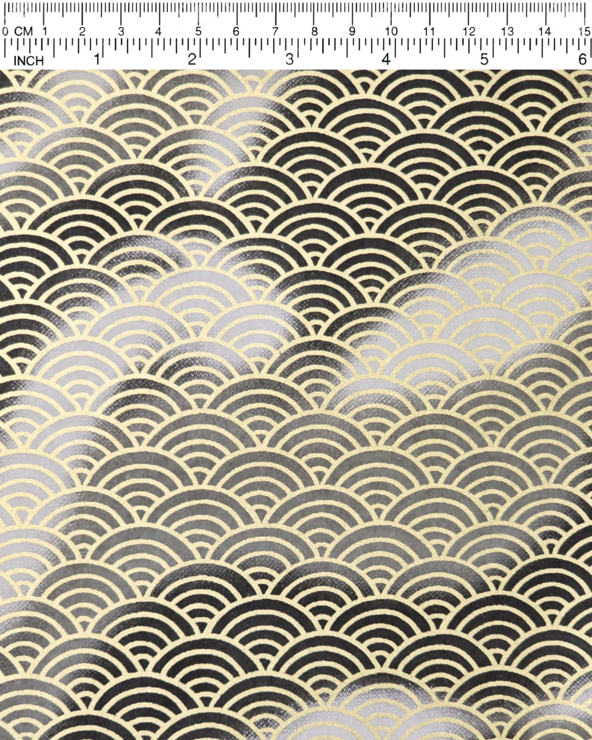 Japanese chiyogami paper featuring a large metallic gold traditional seigaiha (wave crest) pattern on a flowing background in various shades of gray and black, shown next to a ruler for size reference.
