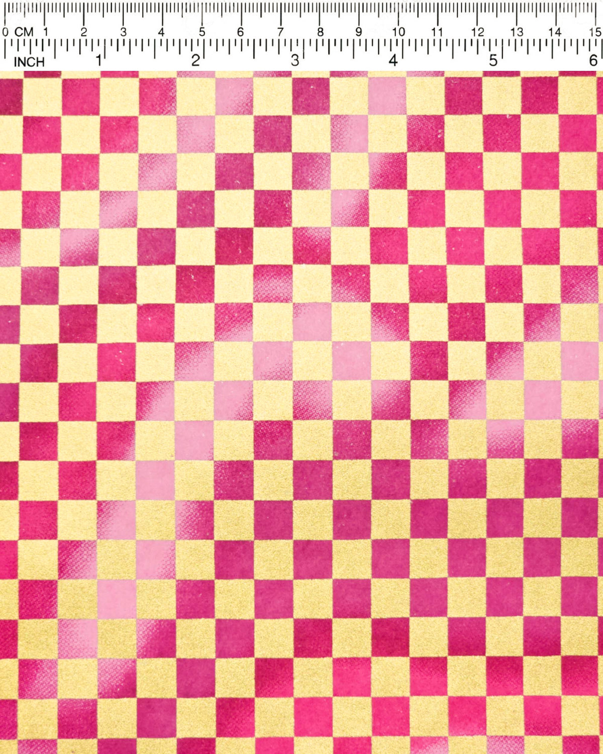 Japanese chiyogami paper featuring a large metallic gold traditional ichimatsu (checker) pattern on a flowing background in various shades of magenta pink, shown next to a ruler for size reference.