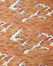 Japanese chiyogami paper featuring metallic gold waves with beige and white detailed waves on a red background. 