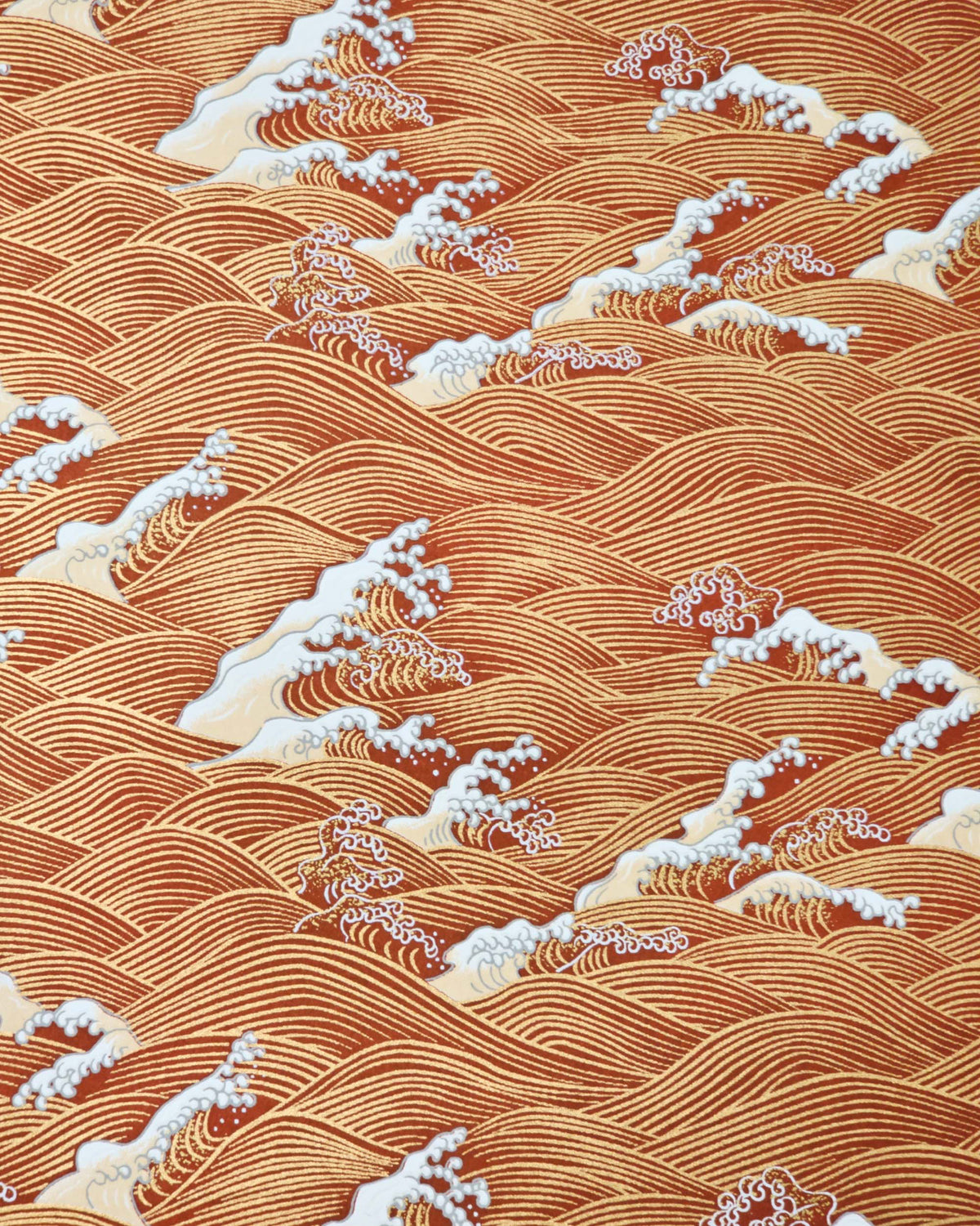 Japanese chiyogami paper featuring metallic gold waves with beige and white detailed waves on a red background. 