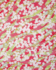 Japanese chiyogami paper featuring pink plum and cherry blossoms with flowing green ribbons on a red and silver seigaihai background with metallic gold details.