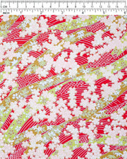 Japanese chiyogami paper featuring pink plum and cherry blossoms with flowing green ribbons on a red and silver seigaihai background with metallic gold details.