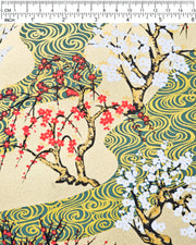 Japanese chiyogami paper featuring red and white plum and cherry blossom trees set against a metallic gold and green water ripple pattern on a gold background, shown next to a ruler for size reference.