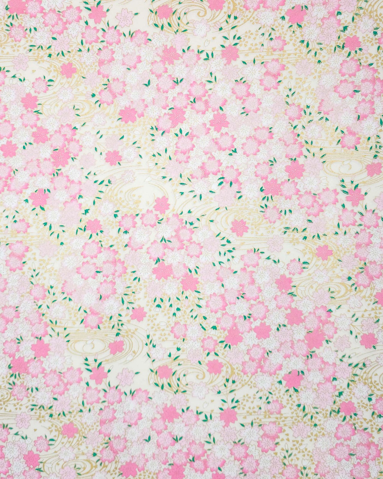 Japanese chiyogami paper featuring light pink cherry blossoms a light cream background with metallic gold details.