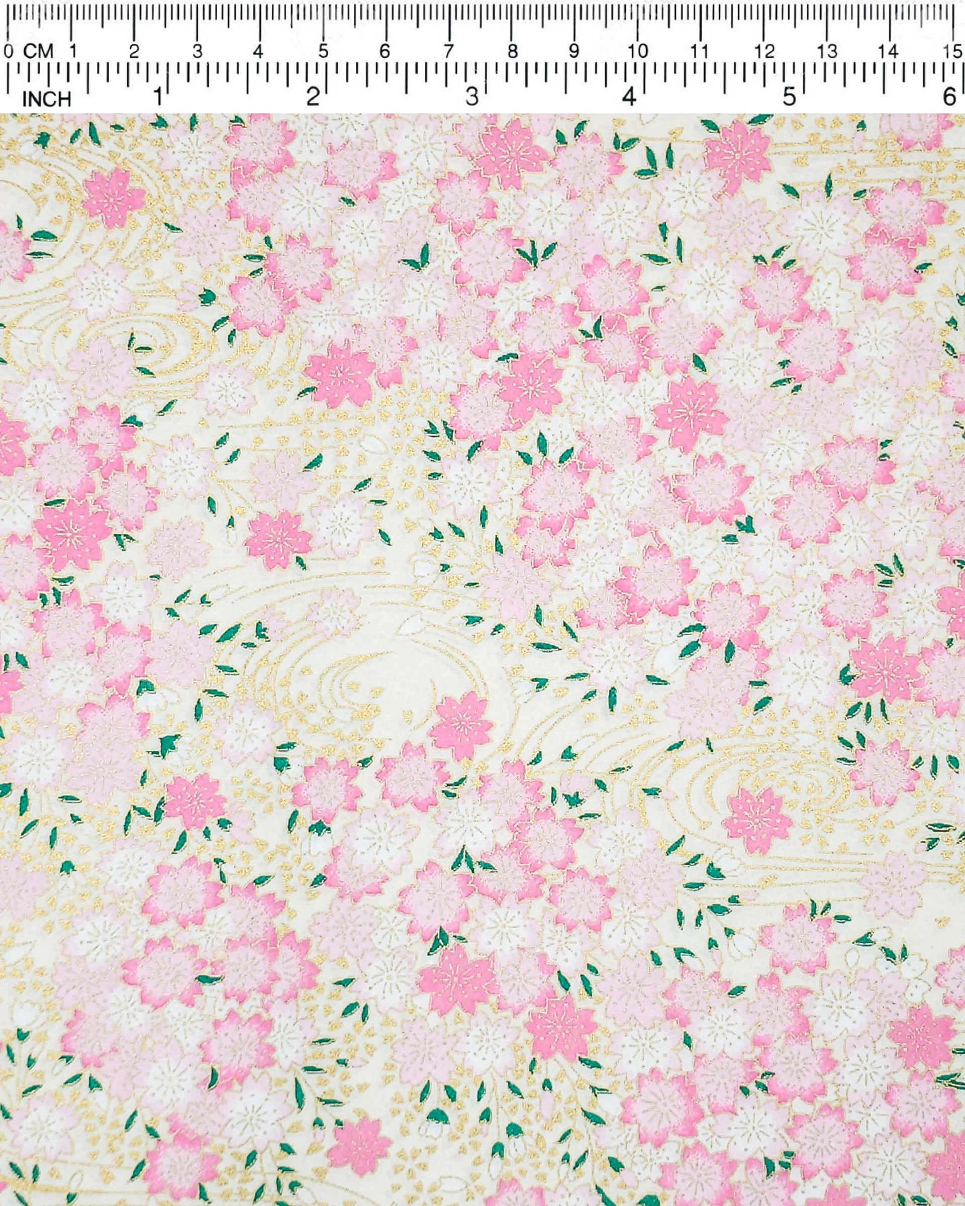 Japanese chiyogami paper featuring light pink cherry blossoms a light cream background with metallic gold details.