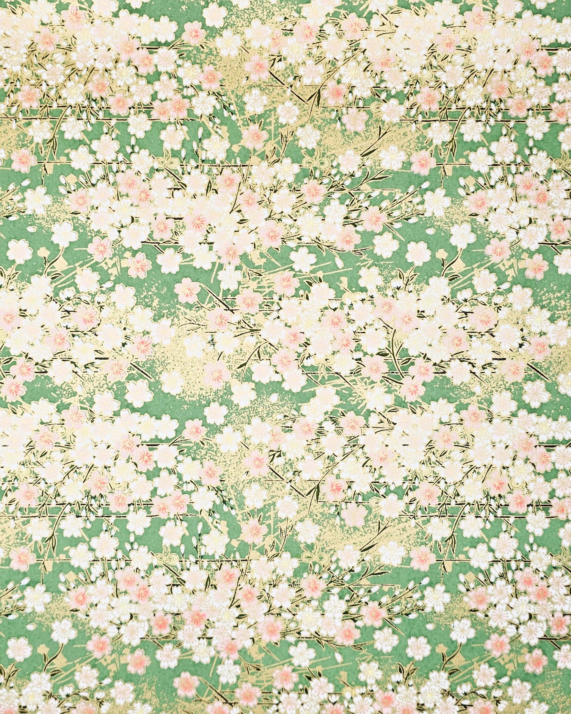 Japanese chiyogami paper featuring light pink and white cherry blossoms on a green background with metallic gold details.