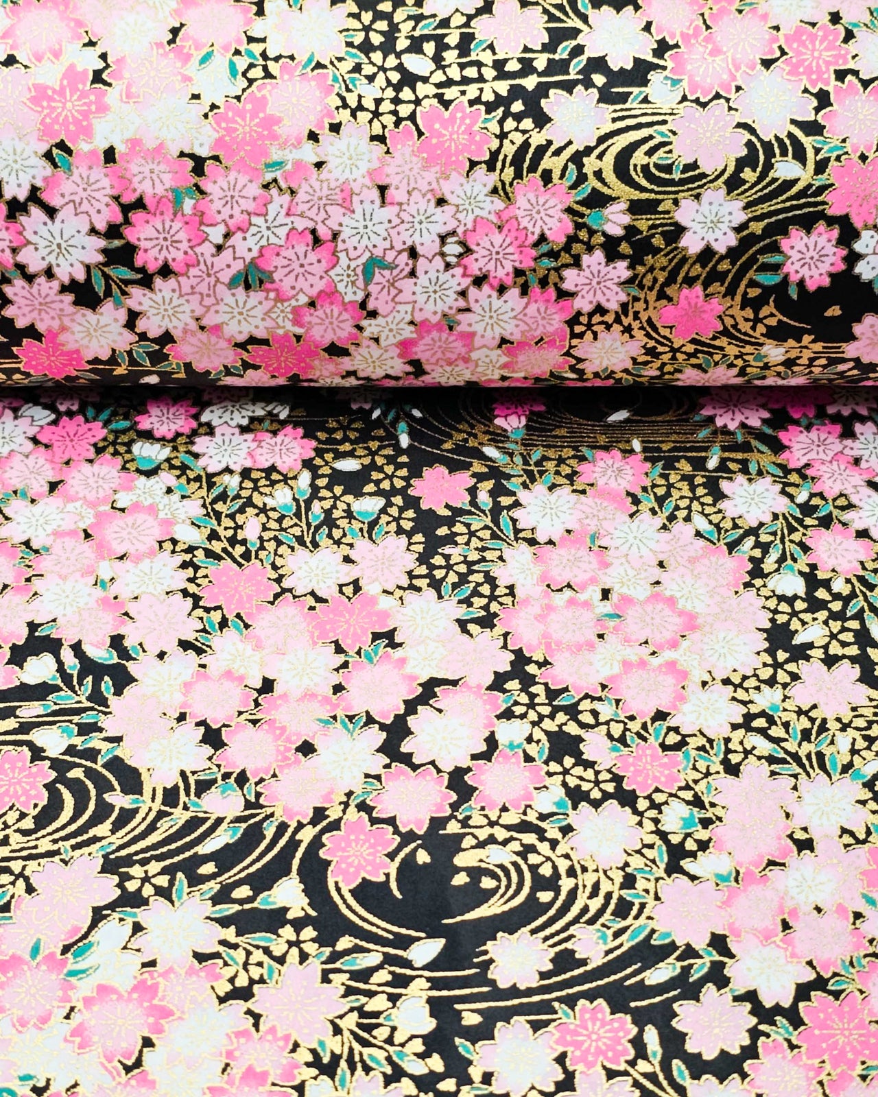 Japanese chiyogami paper featuring pink cherry blossoms on a black background with metallic gold details.