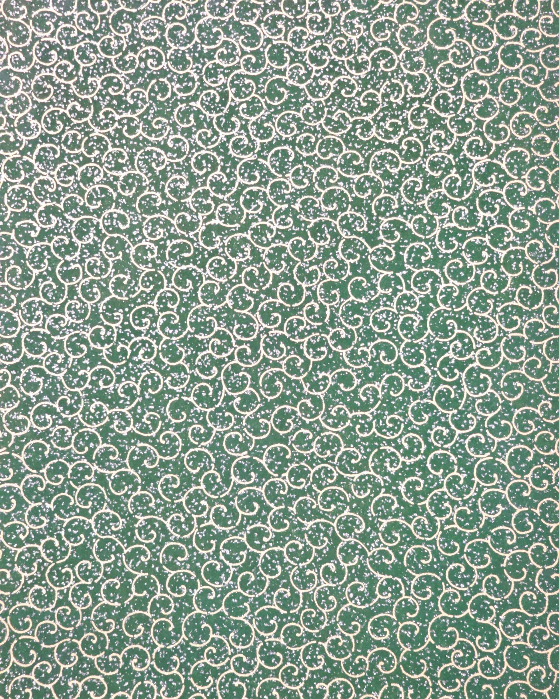 Japanese chiyogami paper featuring metallic gold traditional karakusa design on a green background with silver glitter.
