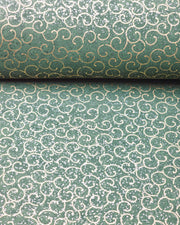 Japanese chiyogami paper featuring metallic gold traditional karakusa design on a green background with silver glitter.