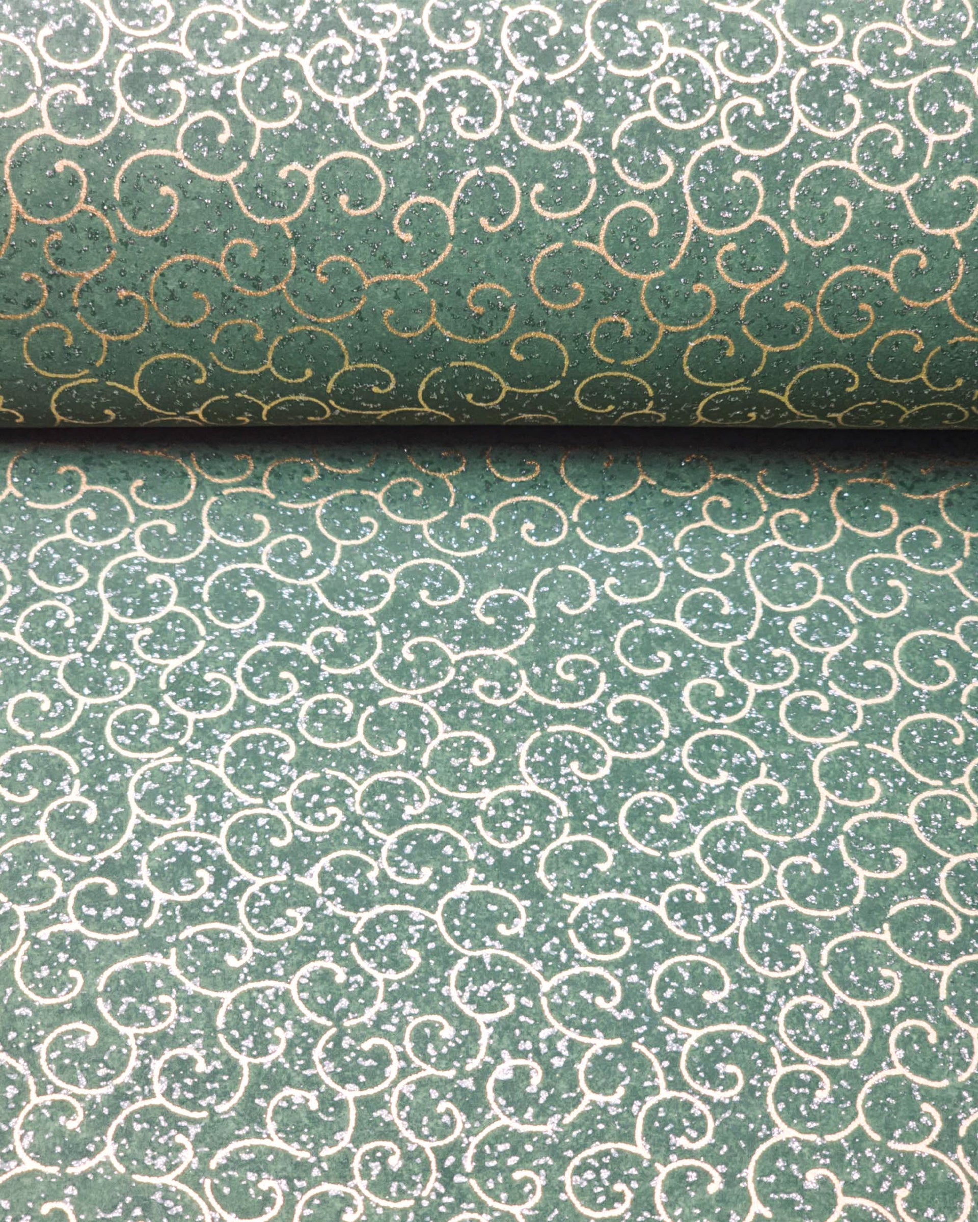 Japanese chiyogami paper featuring metallic gold traditional karakusa design on a green background with silver glitter.