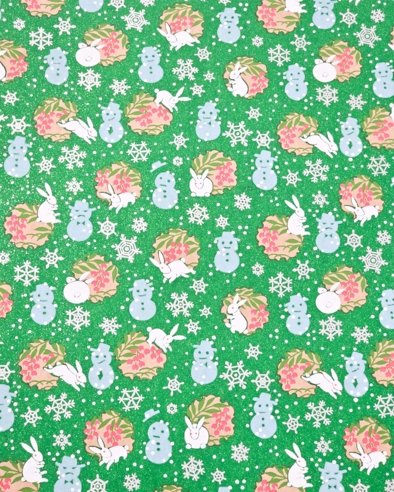 Japanese chiyogami paper featuring light blue snowmen, white rabbits, silver snowflakes, and brown yukiwas with red berries inside on a glitter green background.