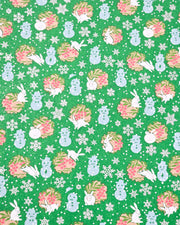 Japanese chiyogami paper featuring light blue snowmen, white rabbits, silver snowflakes, and brown yukiwas with red berries inside on a glitter green background.