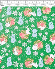 Japanese chiyogami paper featuring light blue snowmen, white rabbits, silver snowflakes, and brown yukiwas with red berries inside on a glitter green background.
