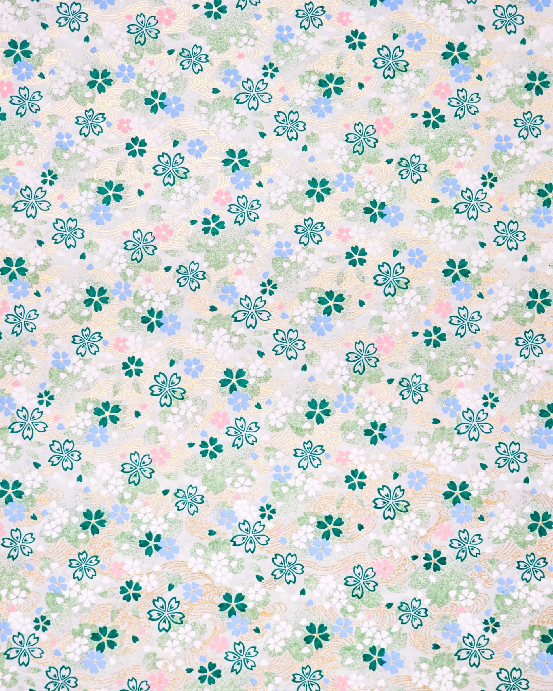 Japanese chiyogami paper featuring green, white, blue, and pink cherry blossoms on a green background with metallic gold details.