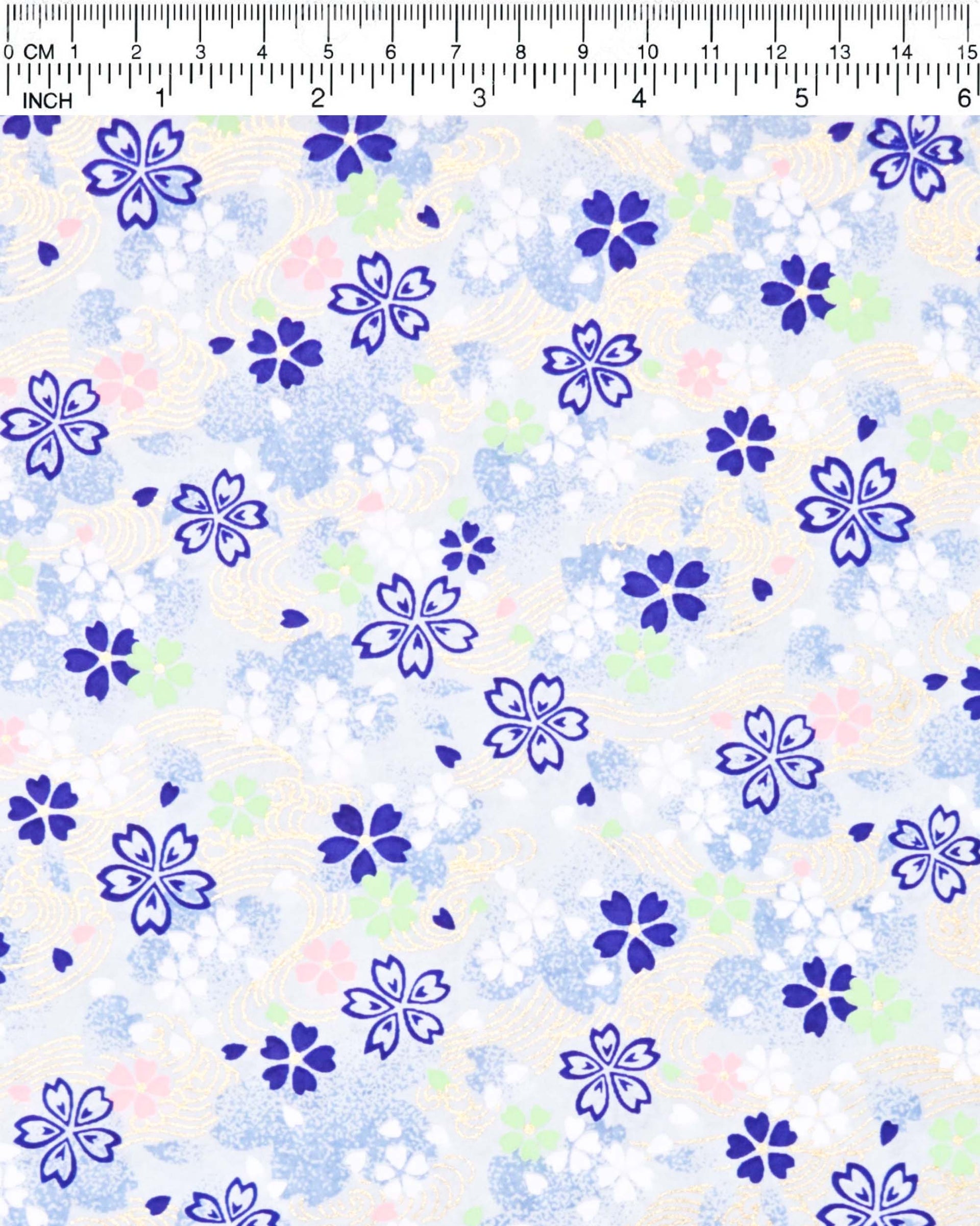 Japanese chiyogami paper featuring blue, white, green, and pink cherry blossoms on a light blue background with metallic gold details.