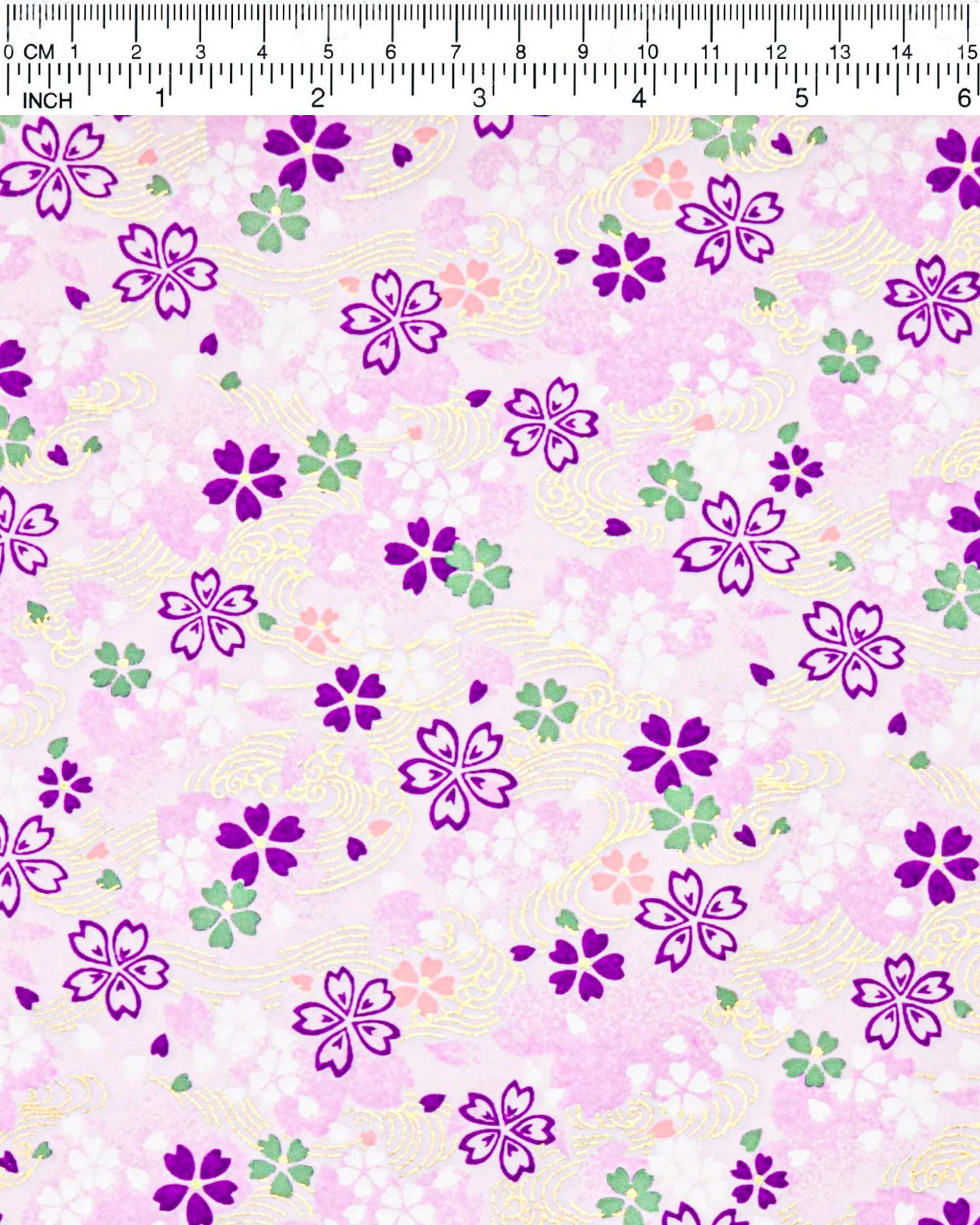 Japanese chiyogami paper featuring purple, white, green, and pink cherry blossoms on a purple background with metallic gold details.