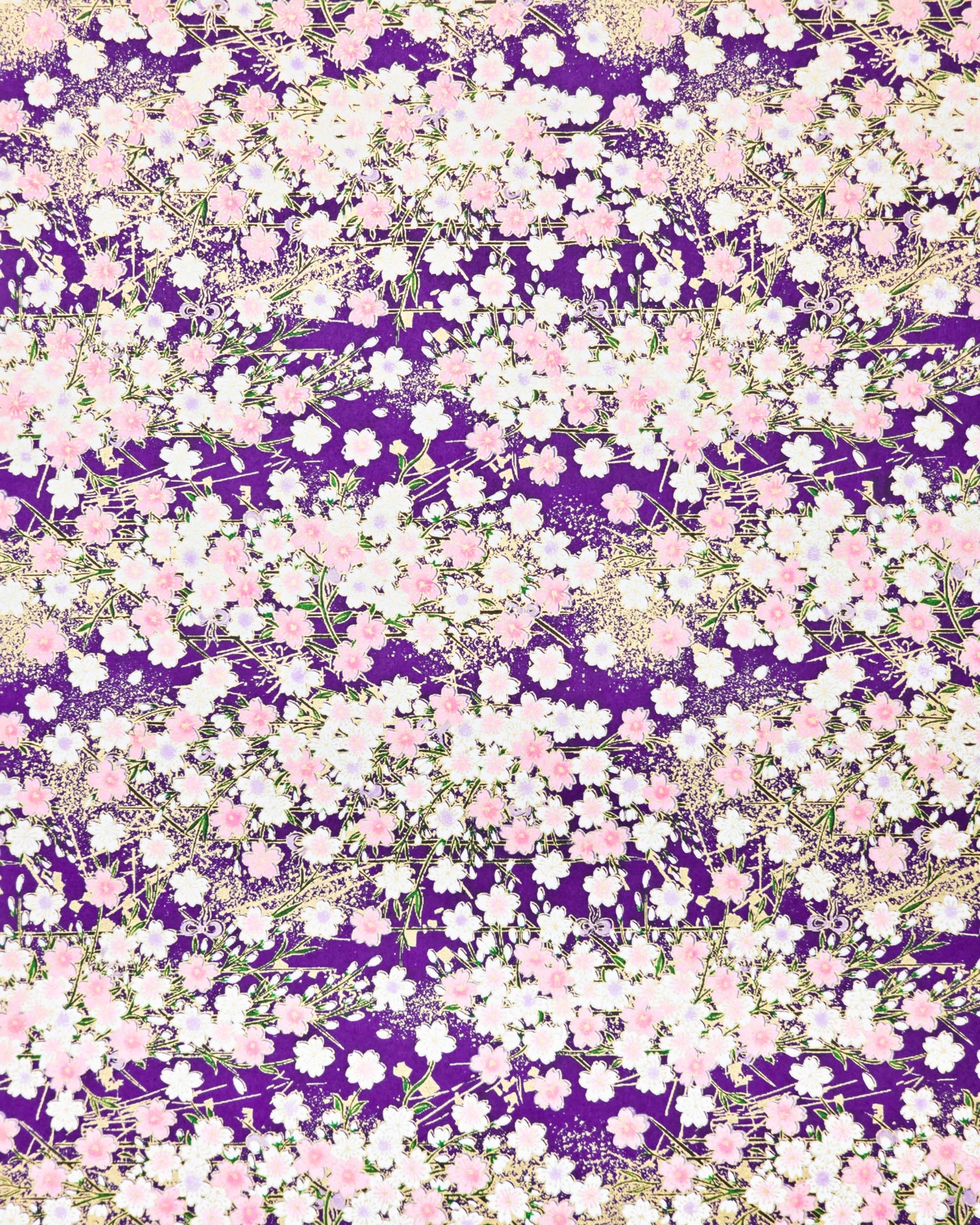 Japanese chiyogami paper featuring light pink and white cherry blossoms on a dark purple background with metallic gold details.