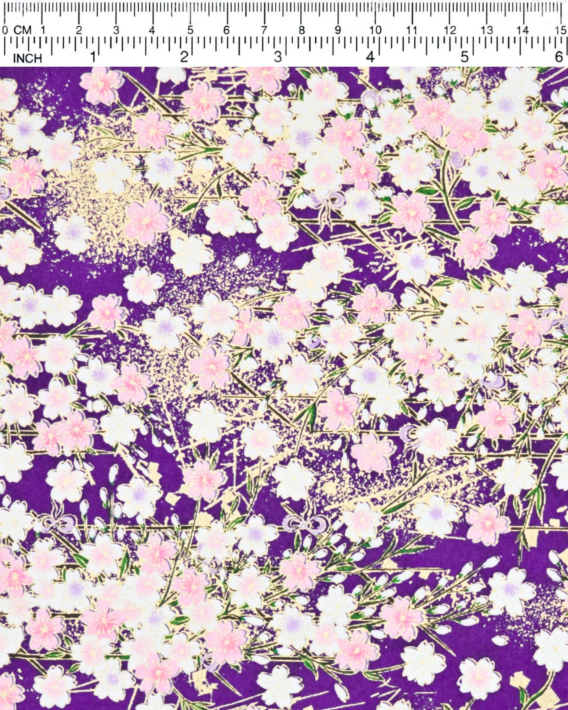 Japanese chiyogami paper featuring light pink and white cherry blossoms on a dark purple background with metallic gold details.
