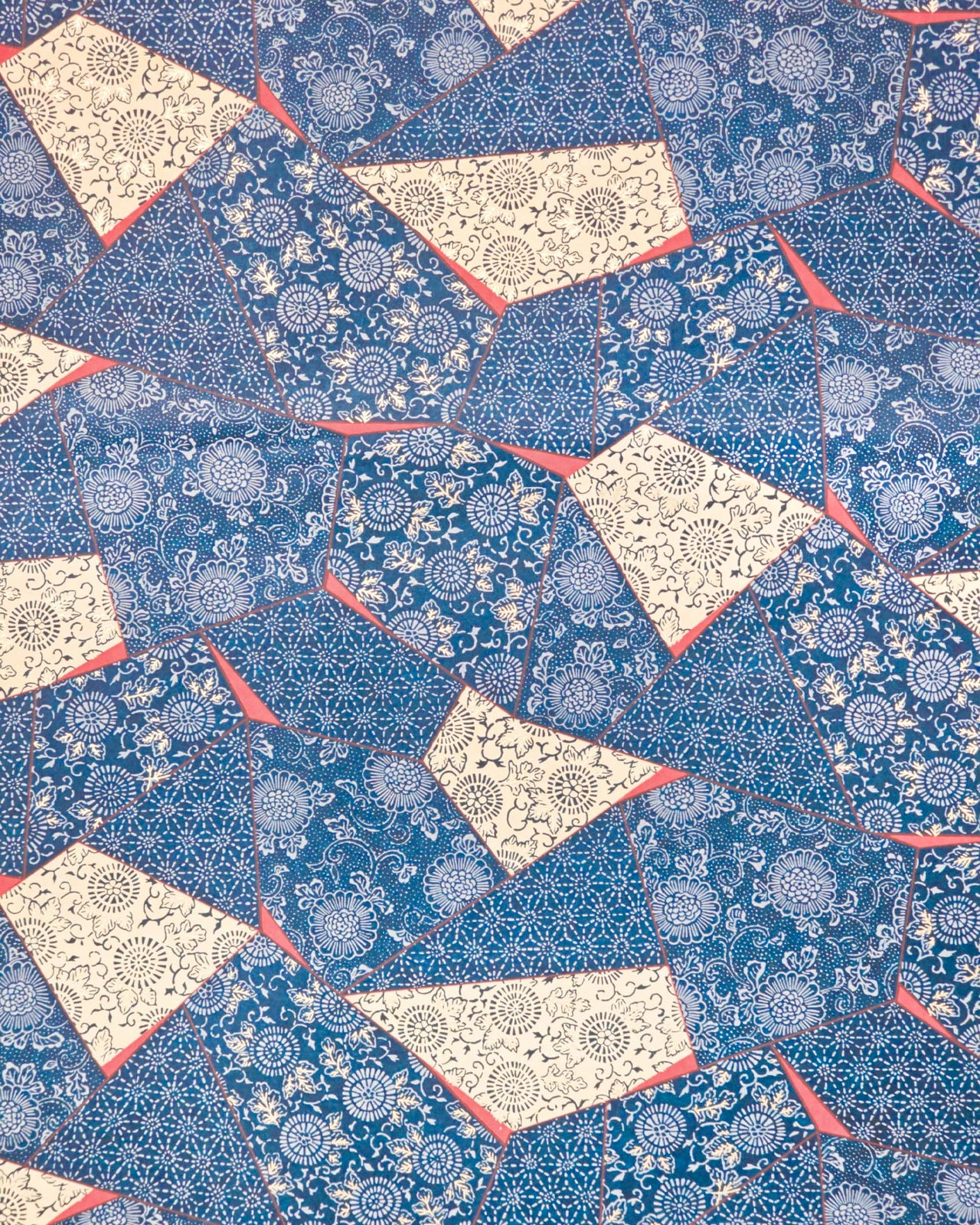 Japanese chiyogami paper featuring blue, beige, and red patches with floral and traditional Japanese patterns with metallic gold details.