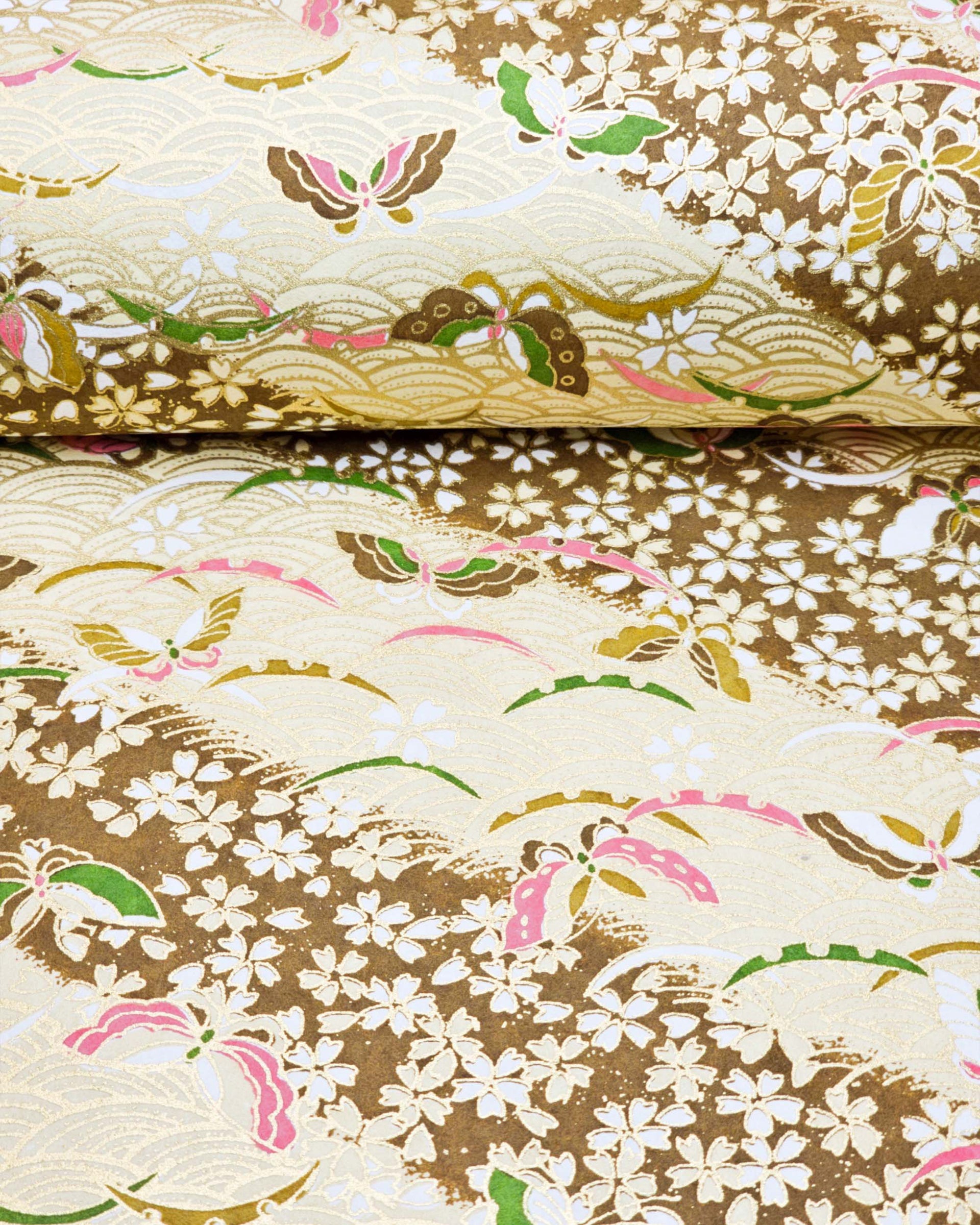 Japanese chiyogami paper featuring brown, pink, and green butterflies and small brown cherry blossoms on a brown seigaiha (wave crest) background with metallic gold details.