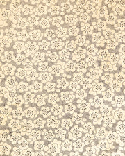 Japanese chiyogami paper featuring black pointillistic plum blossoms on a metallic gold background.
