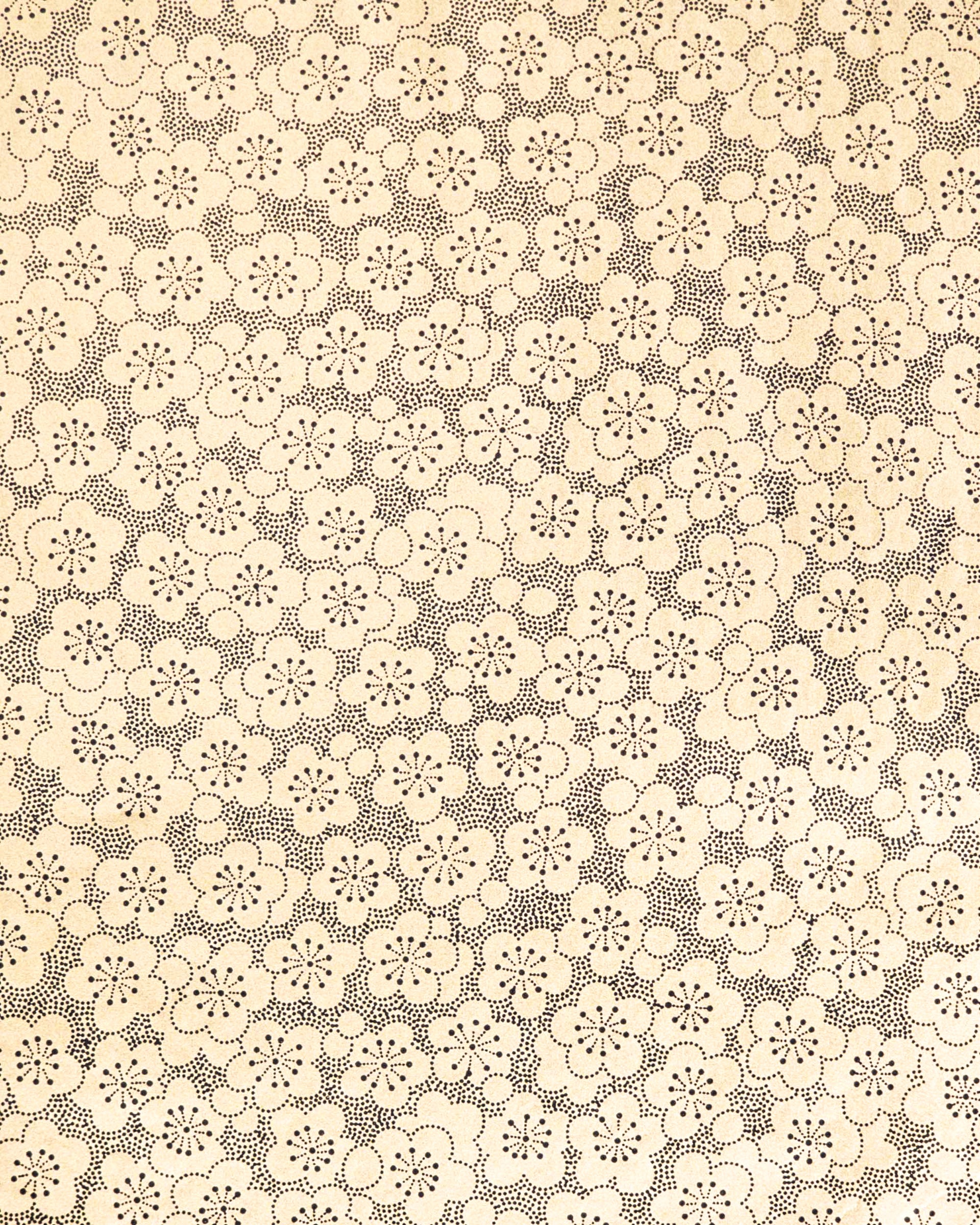 Japanese chiyogami paper featuring black pointillistic plum blossoms on a metallic gold background.