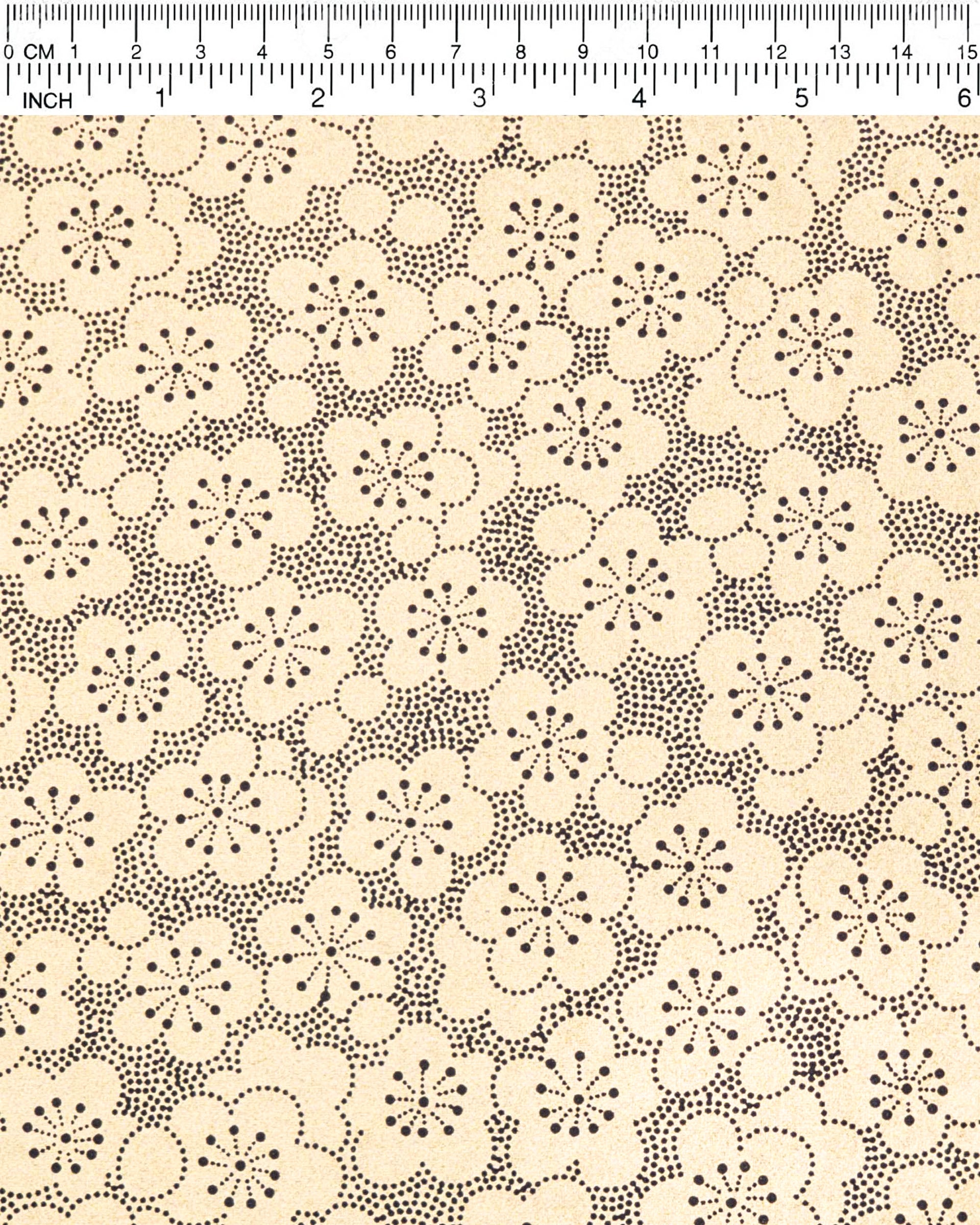 Japanese chiyogami paper featuring black pointillistic plum blossoms on a metallic gold background.