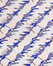 Japanese chiyogami paper featuring black and white katana swords with white and light pink cherry blossoms on a blue background with metallic gold details.