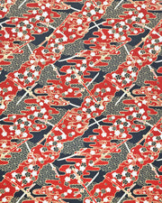 Japanese chiyogami paper featuring red and white katana swords with white and black cherry blossoms on a red and black background with metallic gold details.