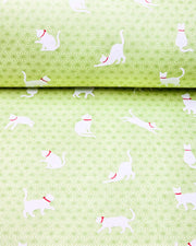 Japanese chiyogami paper featuring assorted white cats with red collars on a light green asanoha (hemp leaf) background.