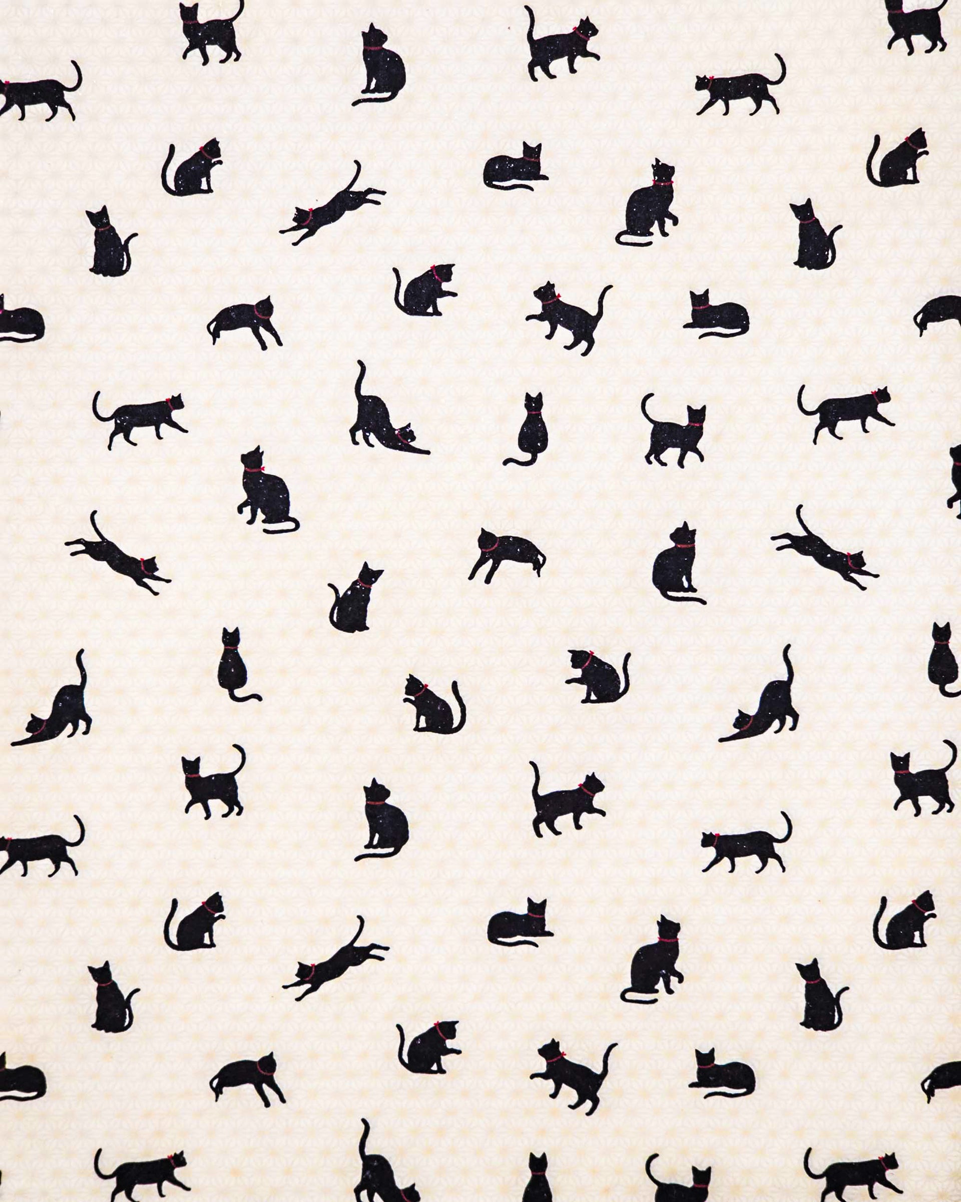 Japanese chiyogami paper featuring assorted black cats with red collars on a light beige asanoha (hemp leaf) background.