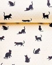 Japanese chiyogami paper featuring assorted black cats with red collars on a light beige asanoha (hemp leaf) background.