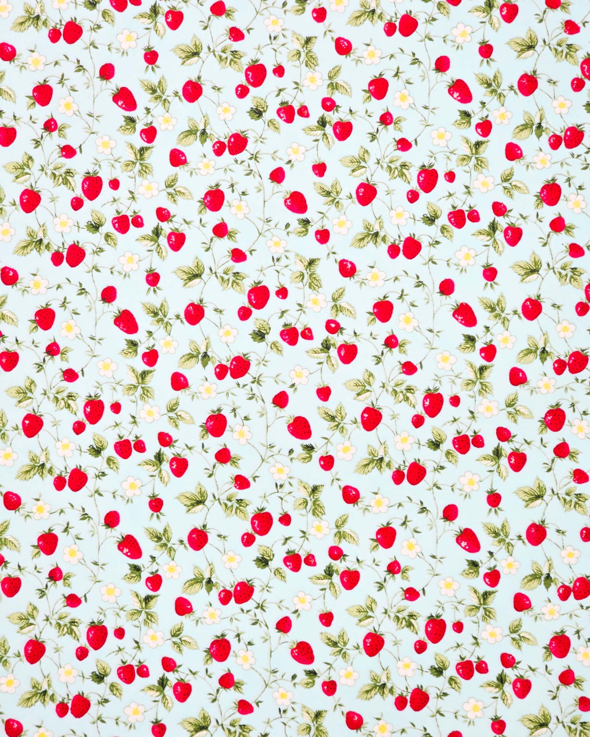 Japanese chiyogami paper featuring red strawberries with green leaves and white flowers with yellow centers on a light blue background. 
