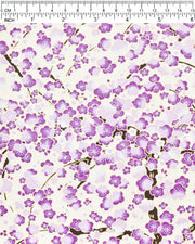 Japanese chiyogami paper featuring purple and white plum blossom trees with brown branches on a cream background with metallic gold details, shown next to a ruler for size reference.