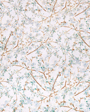 Japanese chiyogami paper featuring light blue and white plum blossoms with dark brown branches and green leaves on a metallic silver background with metallic gold details.
