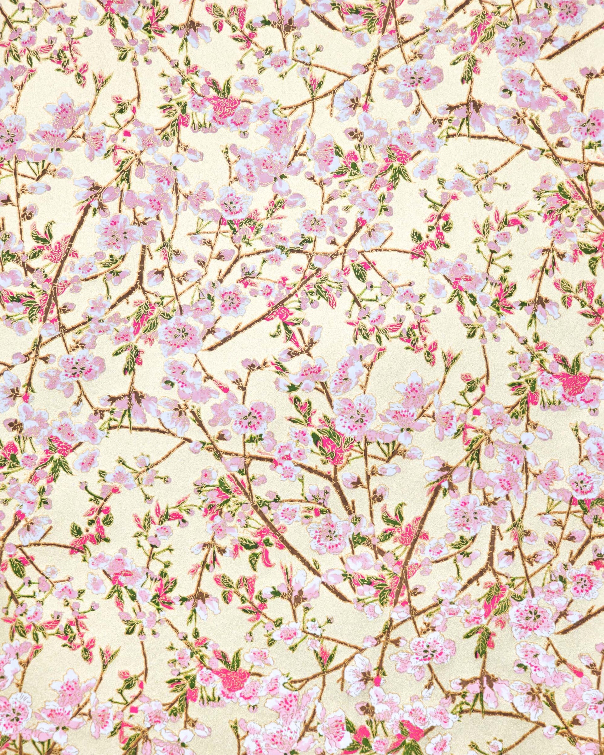 Japanese chiyogami paper featuring light pink and white plum blossoms with dark brown branches and green leaves on a gold background with metallic gold details.