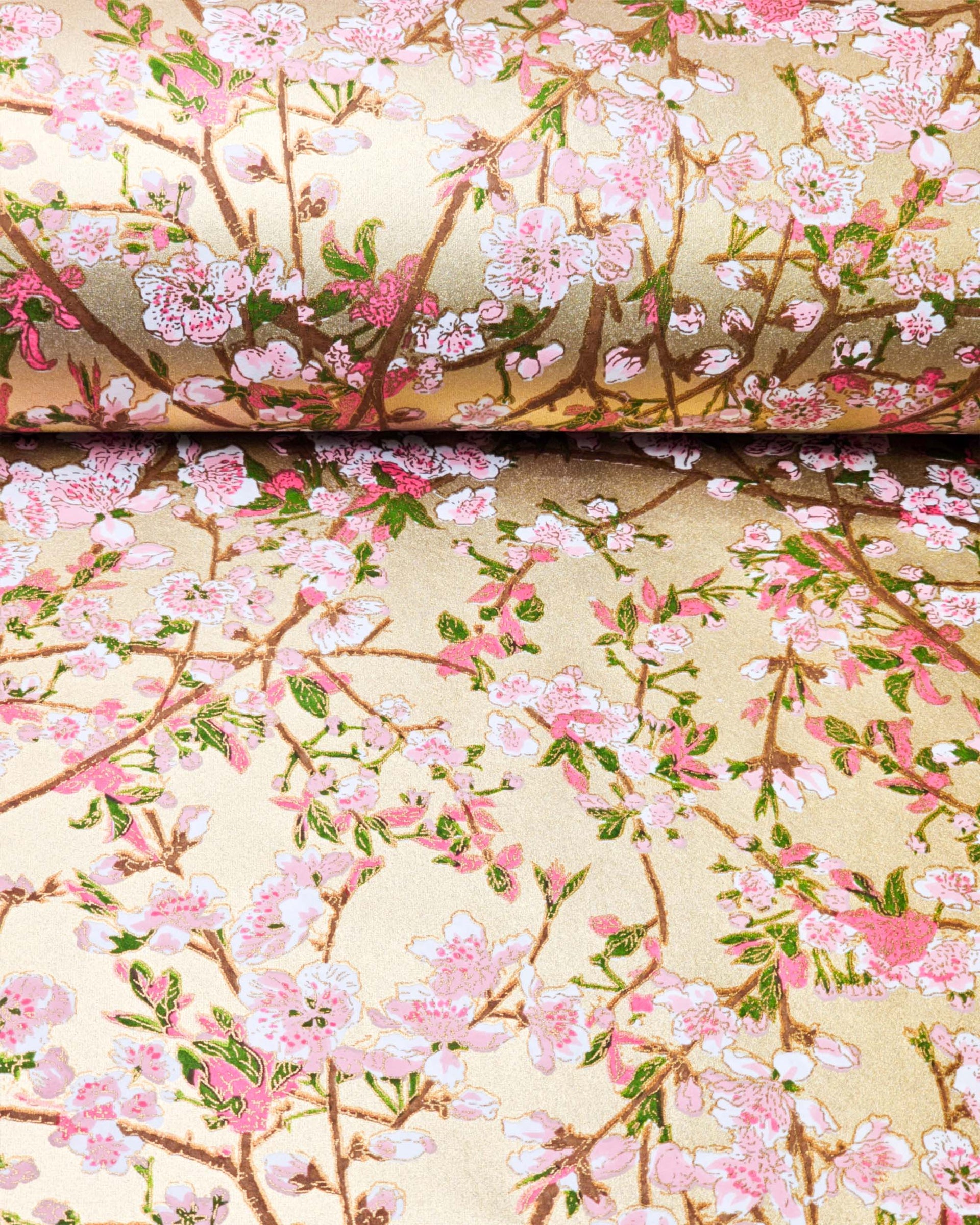 Japanese chiyogami paper featuring light pink and white plum blossoms with dark brown branches and green leaves on a gold background with metallic gold details.